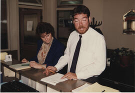 Julie Lewis (accountant) and Kenton Preston (sales manager) at Trish Stirling's main office desk